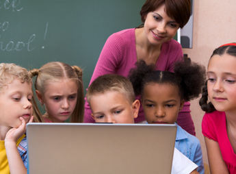 Teacher Using the Computer with Her Class